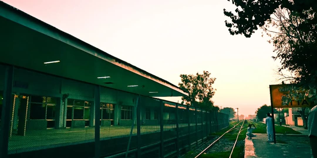 Train travelling through mustard fields and rural countryside near Amritsar in Punjab