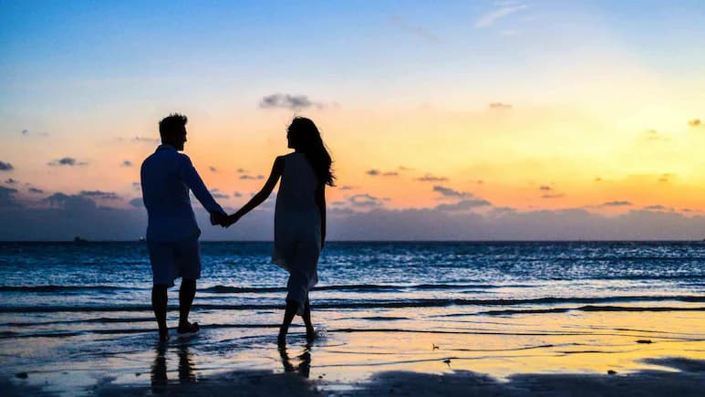 Romantic couple walking along a scenic beach in Puducherry during Valentine’s Day
